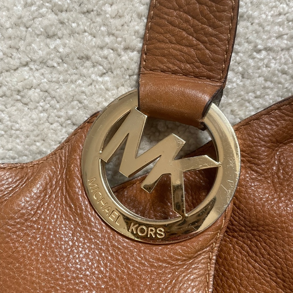 Well loved Michael Kors bag. Gold accents. Bucket bag. Holds a lot.